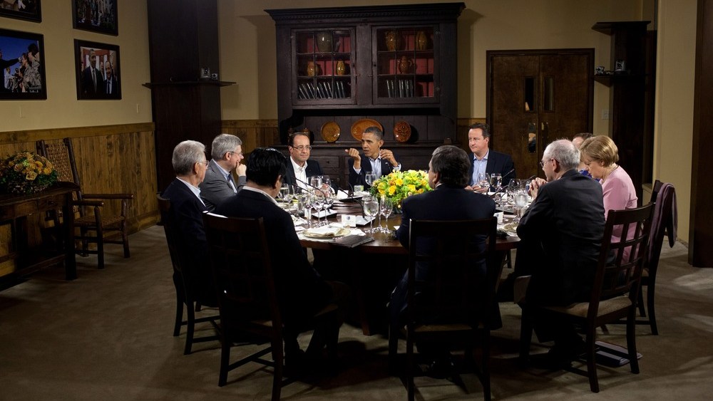 In this handout provided by The White House, President Barack Obama hosts a working dinner in Laurel Cabin during the G8 Summit on May 18, 2012 at Camp David, Maryland.