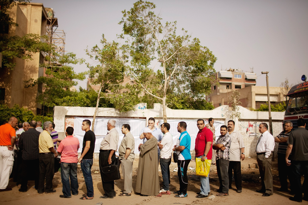 Egyptian voters line up to cast ballots in Basateen, a southern suburb of Cairo, Egypt on Wednesday, May 23, 2012. On Wednesday morning, Egypt commenced two days of presidential voting after 16 months of interim rule by the Supreme Council of Armed...