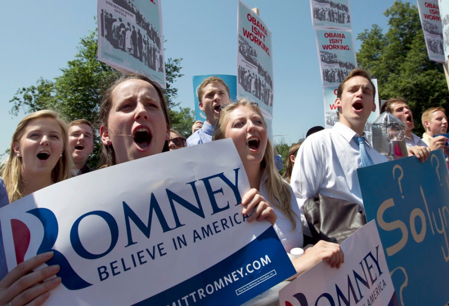 Supporters of Republican presidential candidate and former Massachusetts Gov. Mitt Romney chant slogans and display placards before a speech by Obama strategist David Axelrod in front of the Statehouse, in Boston, Thursday, May 31, 2012.