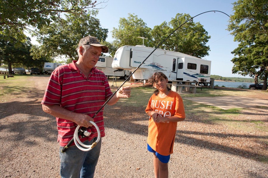 Retiree Dennis Haile inspects a fishing pole in Lake Texoma State Park in Oklahoma.