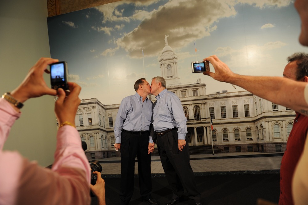 Same-sex couple Ray Durand (L) and his partner Dale Shields kiss while having their picture taken after their wedding ceremony at the Manhattan City Clerk's office on the first day New York State's Marriage Equality Act goes into effect July 24, 2011...