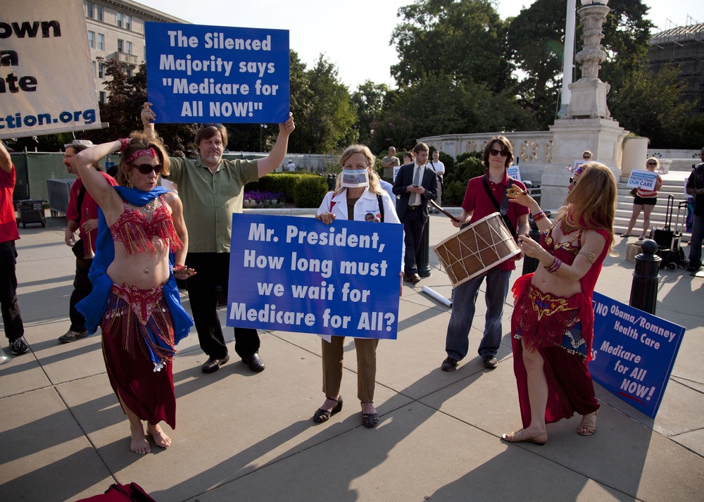 A group of belly dancers in favor of Medicare for all perform outside the Supreme Court in Washington, Thursday, June 28.