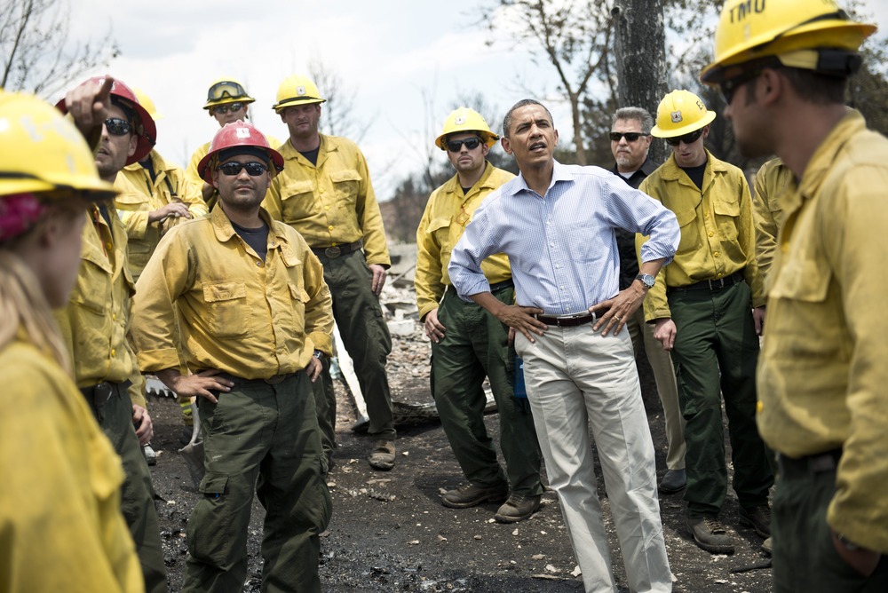 US President Barack Obama pauses with fire fighters while touring the Mountain Shadow neighborhood which was burned by wildfires about 72 hours ago, on June 29, 2012 in Colorado Springs, Colorado. Obama, who declared a major disaster in Colorado and...