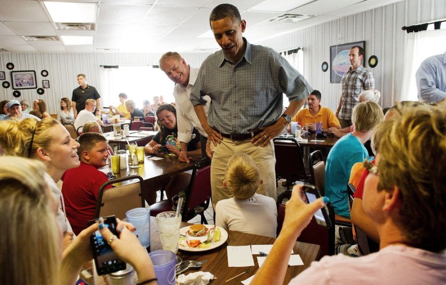 President Obama speaks with patrons at the Kozy Corner restaurant in Oak Harbor, Ohio, July 5, where he made an unannounced visit. Ohio's former Democratic Gov. Ted Strickland, who ate lunch with the president, is seen in the background.