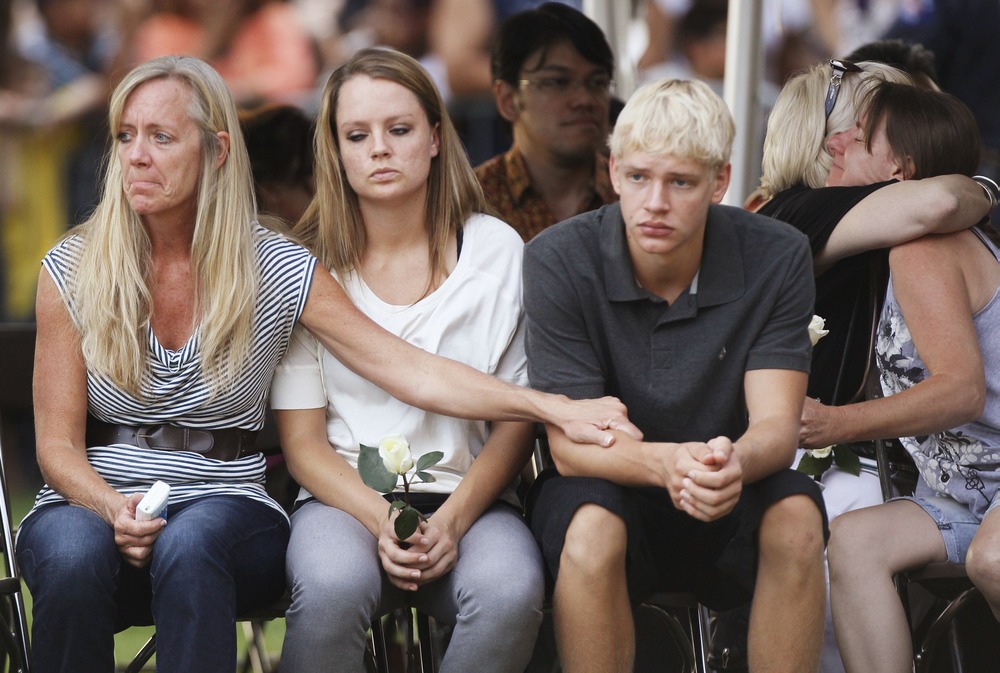 Family members of victims killed in Friday's Century 16 movie theater shootings grieve at a prayer vigil in Aurora, Colo., on Sunday night.