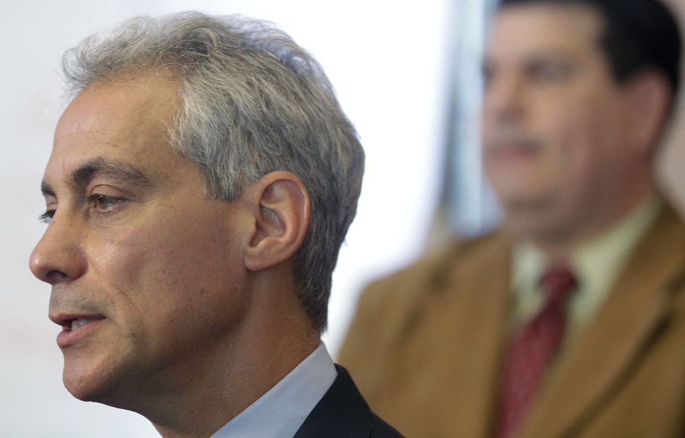 Chicago Mayor Rahm Emanuel speaks during a news conference at Tarkington School of Excellence in Chicago, Tuesday, Sept. 11, 2012 as Vincent Iturralde, right, principal at at Tarkington listens.