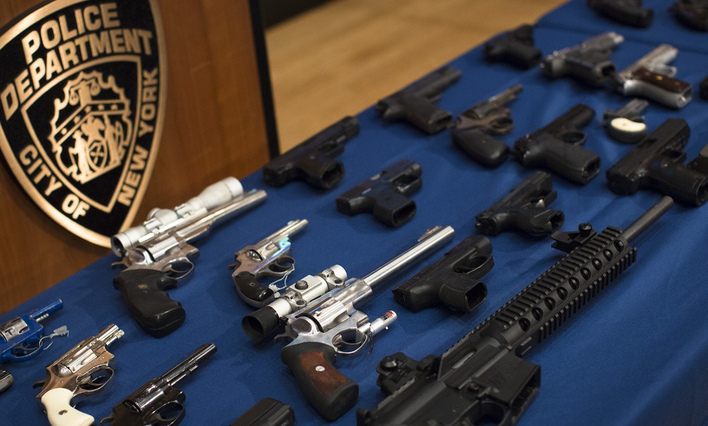 Nearly 100 confiscated illegal firearms rest on a table before a press conference with Mayor Michael Bloomberg, NYPD Commissioner Ray Kelly, and NYC District Attorney Cyrus Vance, Friday, Oct. 12, 2012 in New York.