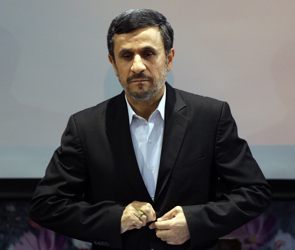 Iranian President Mahmoud Ahmadinejad listens to the Iranian national anthem at the start of a press conference in Tehran, Iran, Tuesday, Oct. 2, 2012.