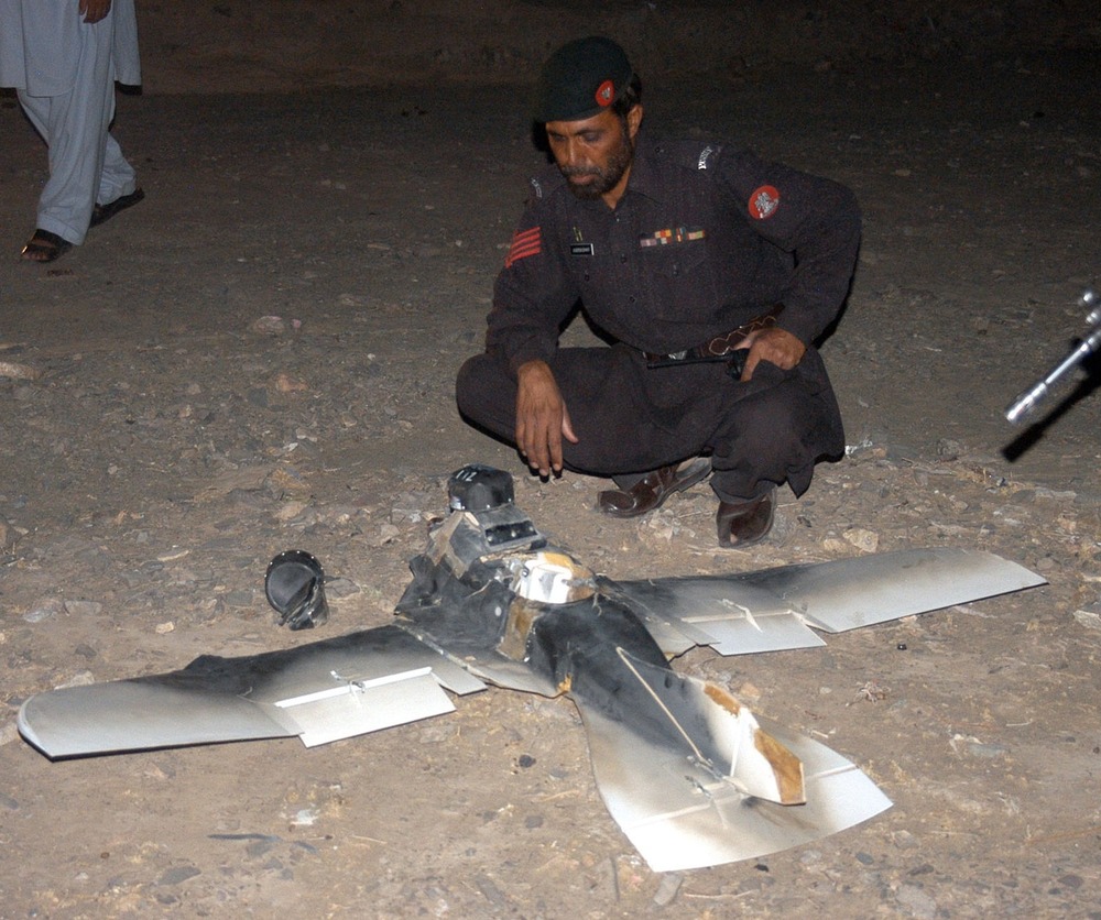 This file photo taken on August 25, 2011 shows Pakistani security personnel examining a crashed US surveillance drone some two kilometers inside Pakistani territory. (ASGHAR ACHAKZAI/AFP/Getty Images)