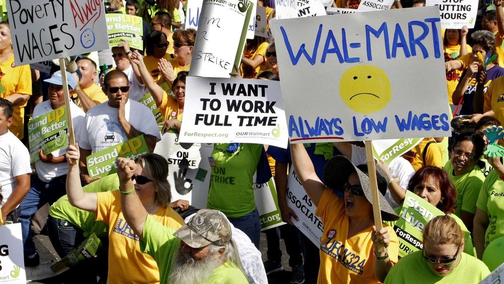 Striking Walmart workers gather during a rally to protest unsafe working conditions and poor wages outside a Walmart store in Pico Rivera, California, October 4, 2012. (REUTERS/Jonathan Alcorn)