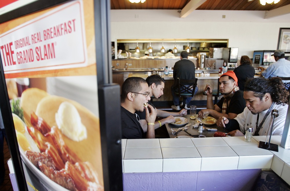Customers eat a free Grand Slam breakfast at a Denny's restaurant in Sunnyvale, Calif., Tuesday, Feb. 3, 2009. (AP Photo/Paul Sakuma)