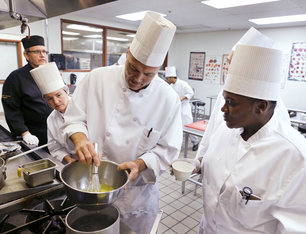 Students in a professional cook class make hollandaise sauce as instructor Larry Baumann, far left, looks on at the Culinary Academy of Las Vegas, Friday, Dec. 14, 2012, in Las Vegas. The academy is funded through a trust created by the culinary and...