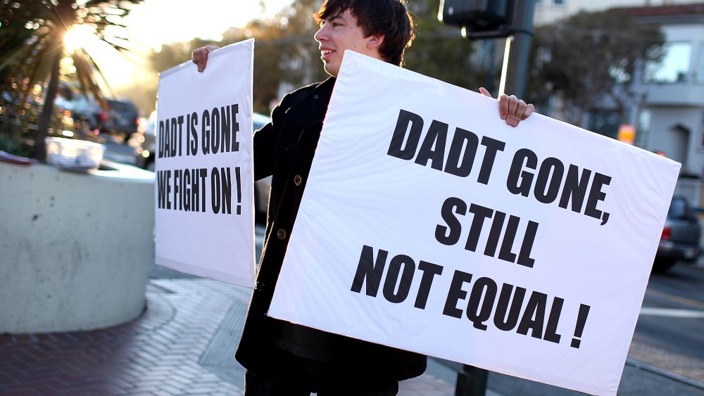 A protestor holds signs as he celebrates the end of "Don't Ask, Don't Tell" but demands equal rights for gays and lesbians on September 20, 2011 in San Francisco, California.
