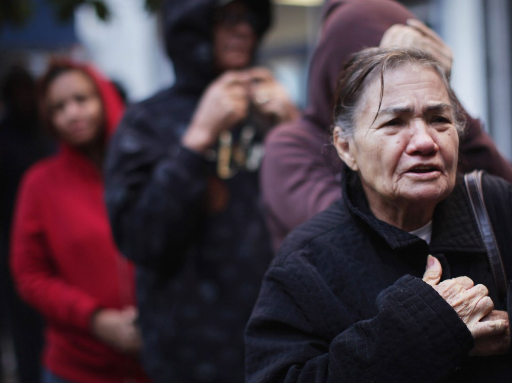 People wait in line to receive free milk from the Milk from the Heart program which makes weekly deliveries to Washington Heights and 12 other locations in Manhattan and the Bronx on October 6, 2011 in New York City. As the economy throughout the...