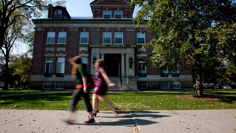 Students walk past an administration building on the Dartmouth College campus.