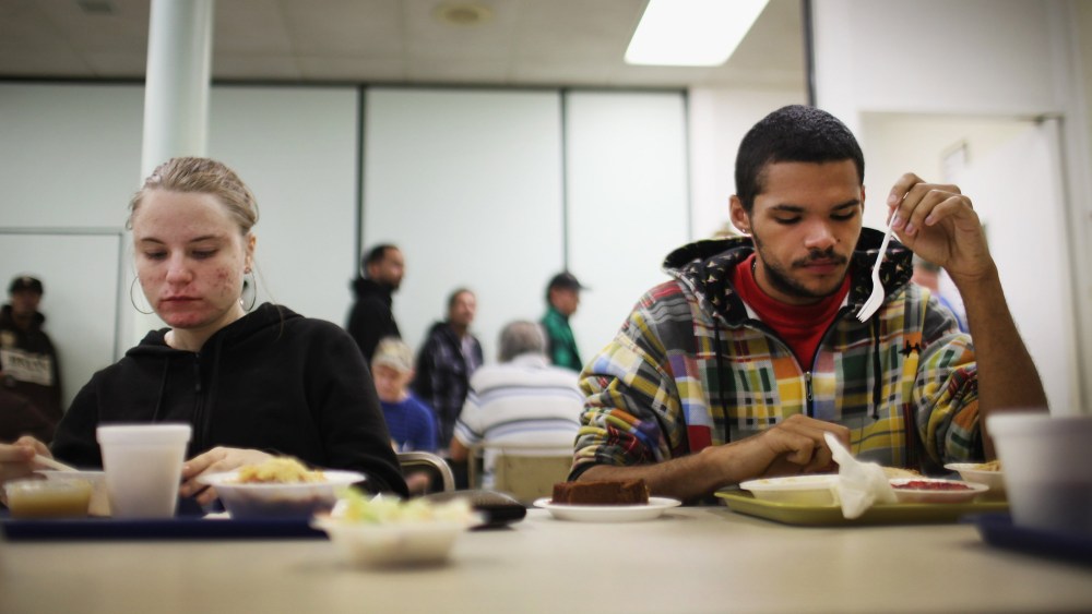 An out of work couple eats lunch at the Central Park United Methodist Church which has a soup kitchen and food pantry on October 20, 2011 in Reading, Pennsylvania.