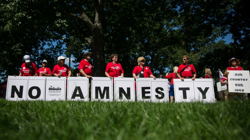 Members of the Rainy Day Patriots, a Tea Party group from Alabama, display a message during the DC March for Jobs in Upper Senate Park near Capitol Hill, on July 15, 2013 in Washington, DC.  (Photo by Drew Angerer/Getty Images)
