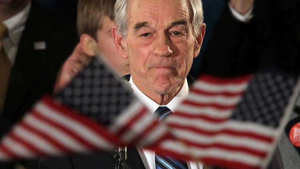 Republican presidential candidate, Texas Republican Rep. Ron Paul, peaks to supporters during a rally on the night of the Iowa caucus at the Courtyard Des Moines Ankeny on January 3, 2012 in Ankeny, Iowa.(Photo by Justin Sullivan/Getty Images)