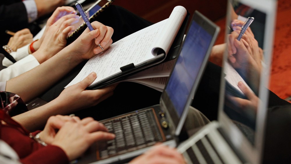 Reporters take notes during a panel discussion at the U.S. Capitol, Jan. 19, 2012.