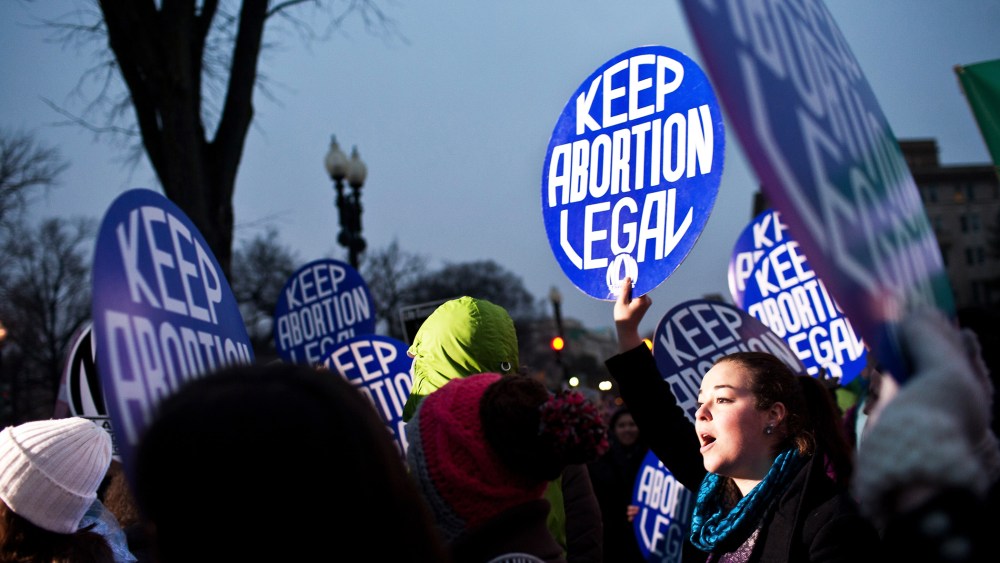 Pro-choice activists hold a vigil outside the U.S. Supreme Court on January 23, 2012 in Washington, DC. (Photo by Brendan Hoffman/Getty)