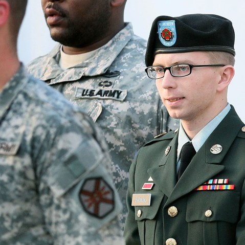 File photo: Army Private Bradley Manning is escorted away from his Article 32 hearing February 23, 2012 in Fort Meade, Maryland. (Photo by Mark Wilson/Getty Images)
