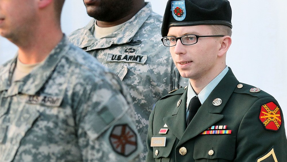 File photo: Army Private Bradley Manning is escorted away from his Article 32 hearing February 23, 2012 in Fort Meade, Maryland. (Photo by Mark Wilson/Getty Images)