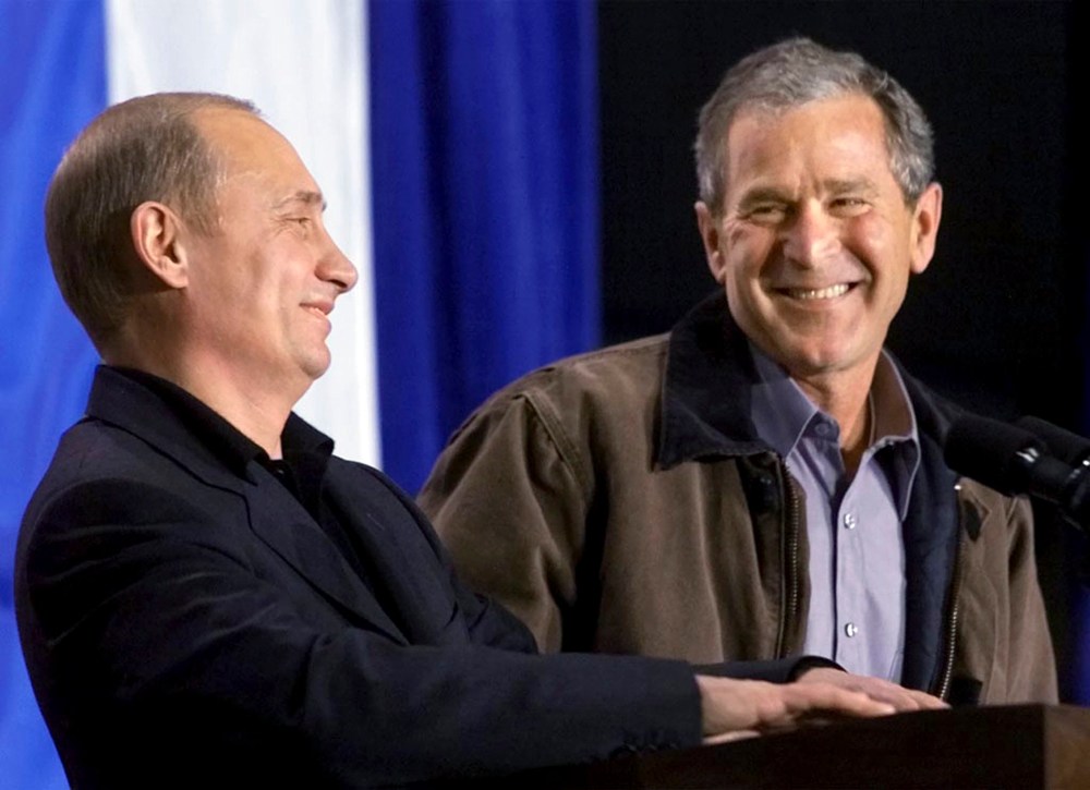 U.S. President George W. Bush shares a laugh with Russian President Vladimir Putin in Crawford, Texas, in this November 15, 2001 file photo.