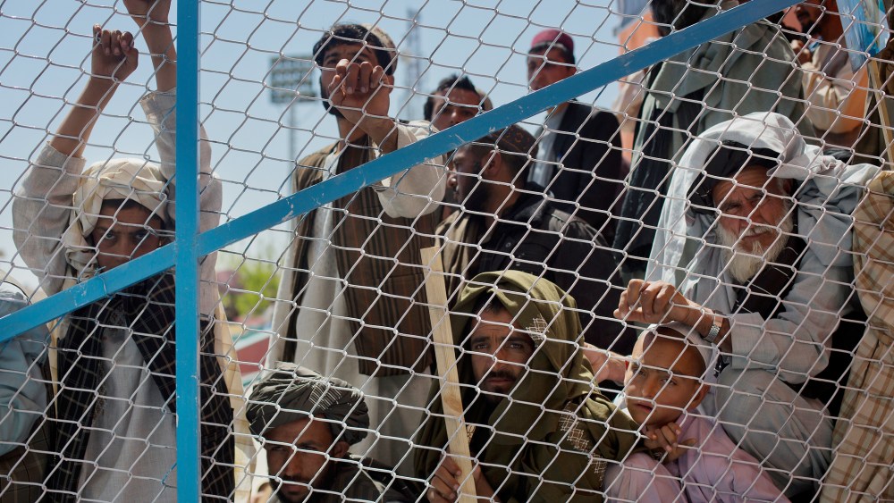 Supporters listen as Afghan presidential candidate Dr. Abdullah Abdullah to address a rally in Kandahar, Afghanistan, on March 30, 2014.
