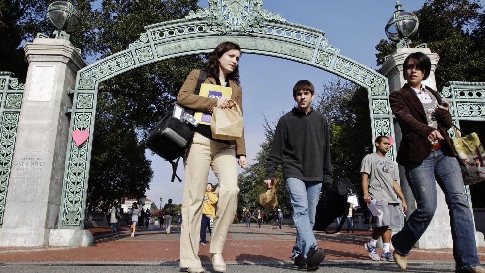 University of California Berkeley students walk through Sather Gate on the campus in Berkeley, Calif. (Photo by Paul Sakuma/AP)