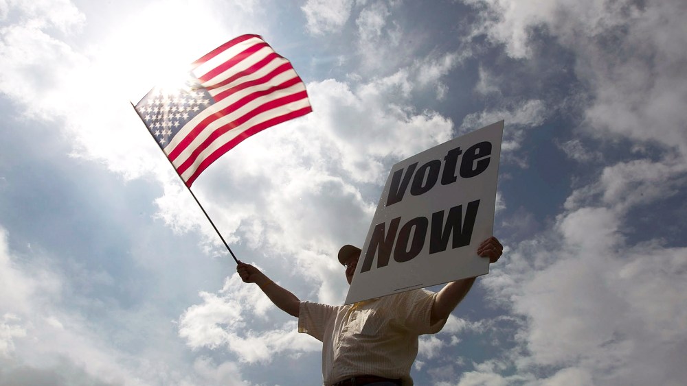 JayDanny Cooper urges Alabama residents to vote in the primary along the side of a highway March 13, 2012 in Birmingham, Ala. (Photo by Win McNamee/Getty)