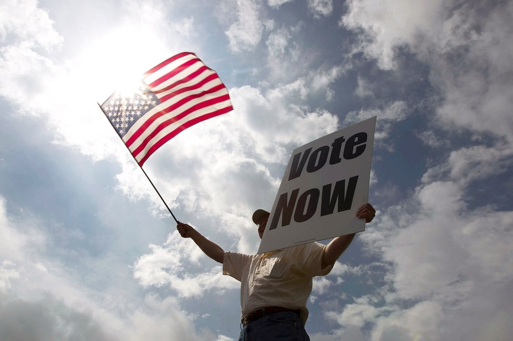 JayDanny Cooper urges Alabama residents to vote in the primary along the side of a highway March 13, 2012 in Birmingham, Ala. (Photo by Win McNamee/Getty)