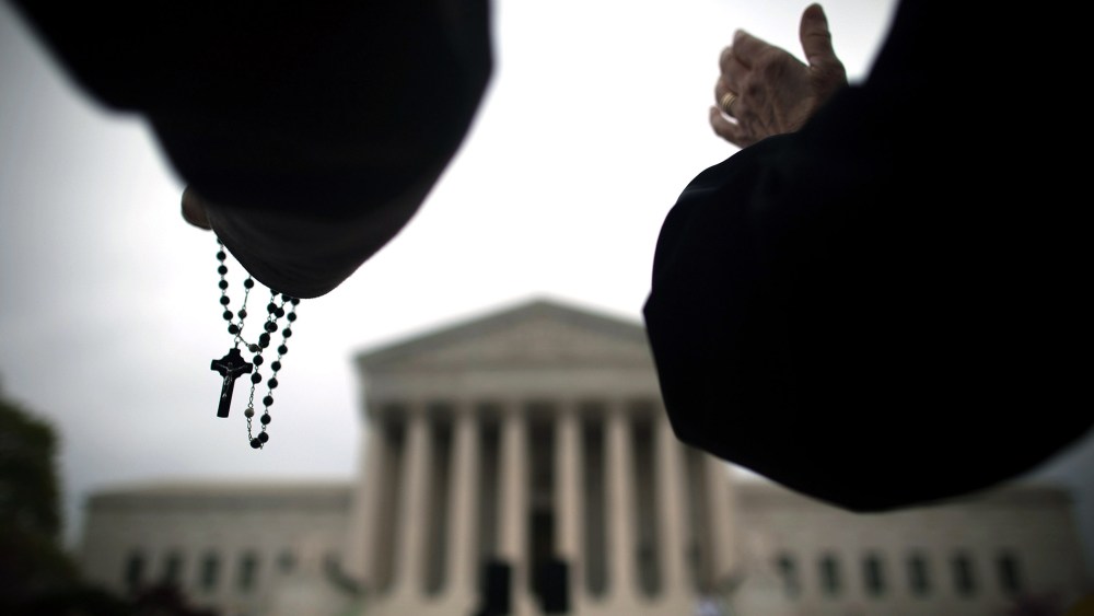 Religious activists lead a prayer vigil outside the Supreme Court on March 25, 2012 in Washington, DC.