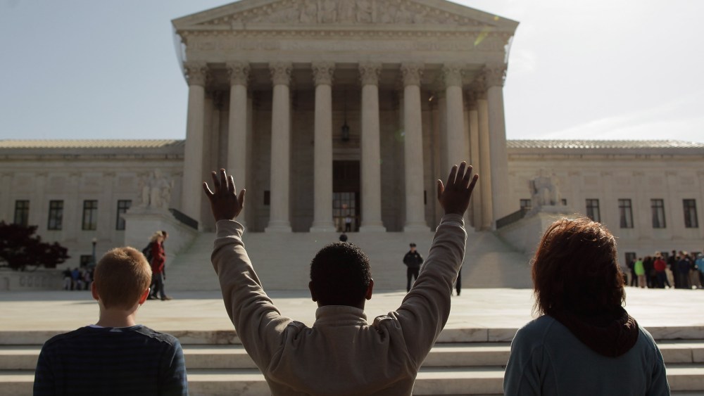 Members of the anti-abortion group Bound4Life pray outside the U.S. Supreme Court on the third day of oral arguements over the constitutionality of the Patient Protection and Affordable Care Act March 28, 2012 in Washington, D.C.