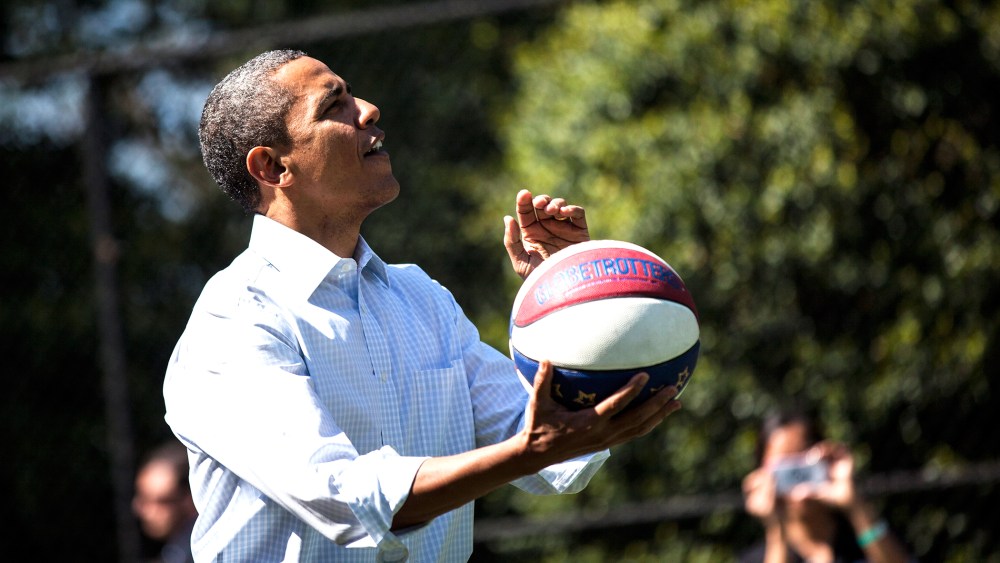 President Barack Obama shoots a basketball while participating in a basketball station with the Harlem Globetrotters during the annual Easter Egg Roll on the South Lawn of the White House April 9, 2012 in Washington, D.C. (Photo by Brendan Smialowski/AFP/