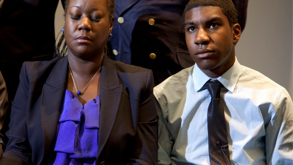 File Photo: The mother of Trayvon Martin, Sybrina Fulton (C) closes her eyes as she and  Trayvon's brother Jahvaris Fulton (R) watch a news conference on Wednesday, April 11, 2012, in Washington, DC as special prosecutor Angela Corey in Sanford,...