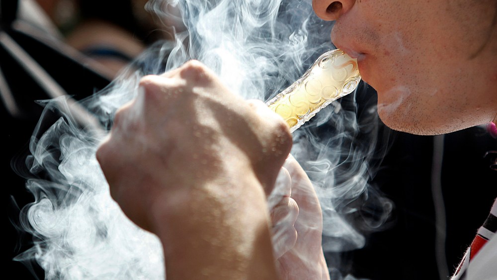 A man smokes as thousands gathered to celebrate the state's nedicinal marijuana laws and collectively light up at 4:20 p.m. in Civic Center Park April 20, 2012 in Denver, Colo.