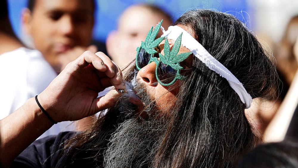 A man smokes a joint in Civic Center Park in Denver, Colorado.