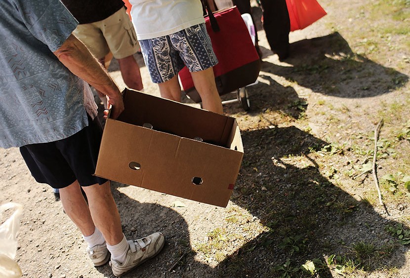 People wait in line with boxes to carry food during a food distribution by the Food Bank of the Southern Tier Mobile Food Pantry on June 20, 2012 in Oswego, New York. (Photo by Spencer Platt/Getty Images)