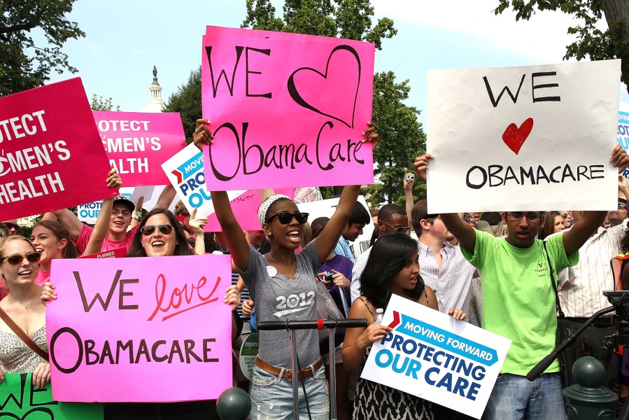 Obamacare supporters react to the  U.S. Supreme Court decision to uphold President Obama's health care law, on June 28, 2012 in Washington, D.C.