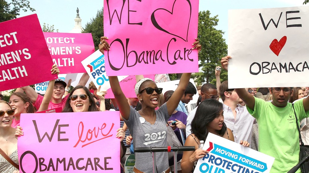 File Photo: Obamacare supporters react to the  U.S. Supreme Court decision to uphold President Obama's health care law, on June 28, 2012 in Washington, DC. Today the high court upheld the whole healthcare law of the Obama Administration.  (Photo by...