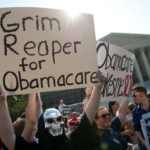 File Photo: Opponents of the Affordable Care Act rally before the Supreme announces its decision about the constitutionality of the president's efforts on health care reform. (Photo by Chris Maddaloni/CQ Roll Call, File)