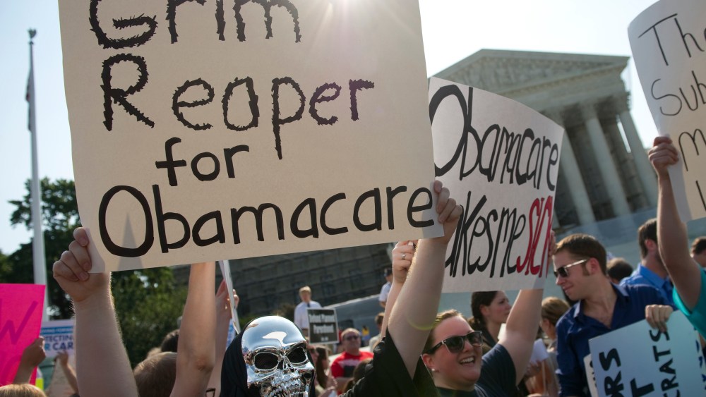 File Photo: Opponents of the Affordable Care Act rally before the Supreme announces its decision about the constitutionality of the president's efforts on health care reform. (Photo by Chris Maddaloni/CQ Roll Call, File)
