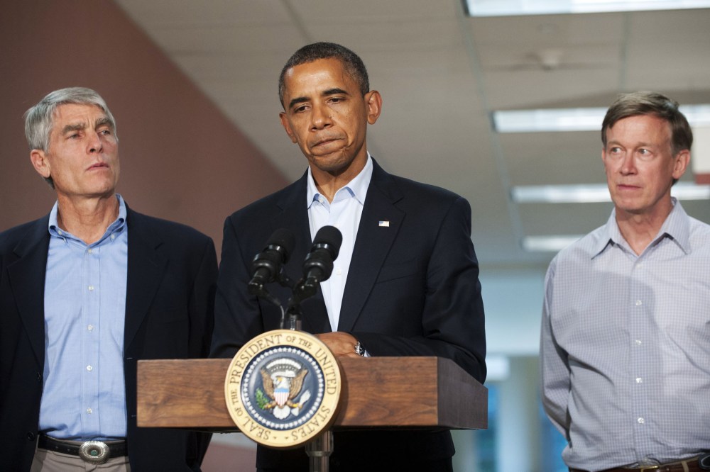 US President Barack Obama speaks alongside Colorado Senator Mark Udall and Colorado Governor John Hickenlooper (R) at the University of Colorado Hospital in Aurora, Colorado, July 22, 2012.