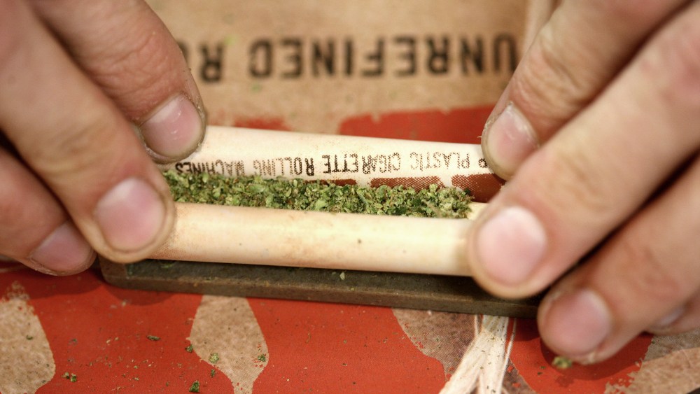 A "budtender" rolls a marijuana cigarette for a patient at Perennial Holistic Wellness Center medical marijuana dispensary, on July 25, 2012 in Los Angeles, California.