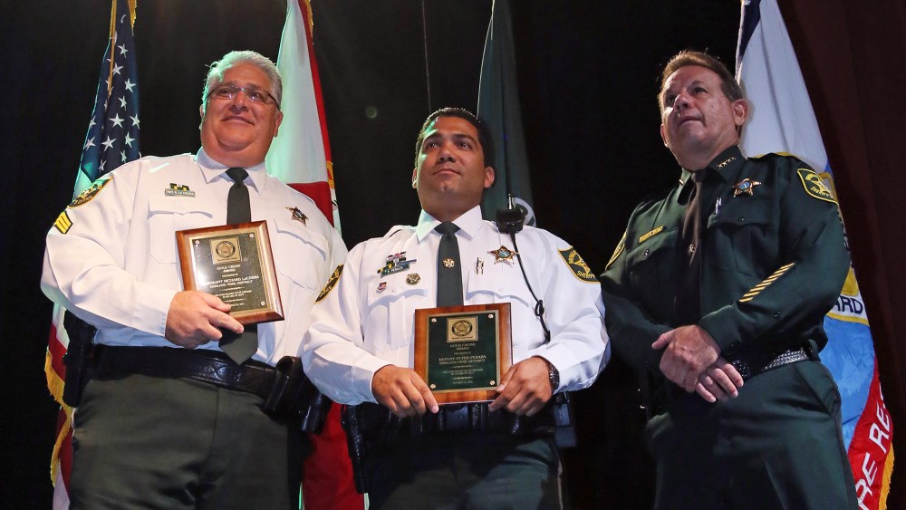 Sgt. Richard LaCerra, left, and Deputy Peter Peraza received Gold Cross Awards from Sheriff Scott Israel during the Broward Sheriff's Office Awards Ceremony, Oct. 22, 2013, in Fort Lauderdale, Fla. (Photo by Amy Beth Bennett/Sun Sentinel)
