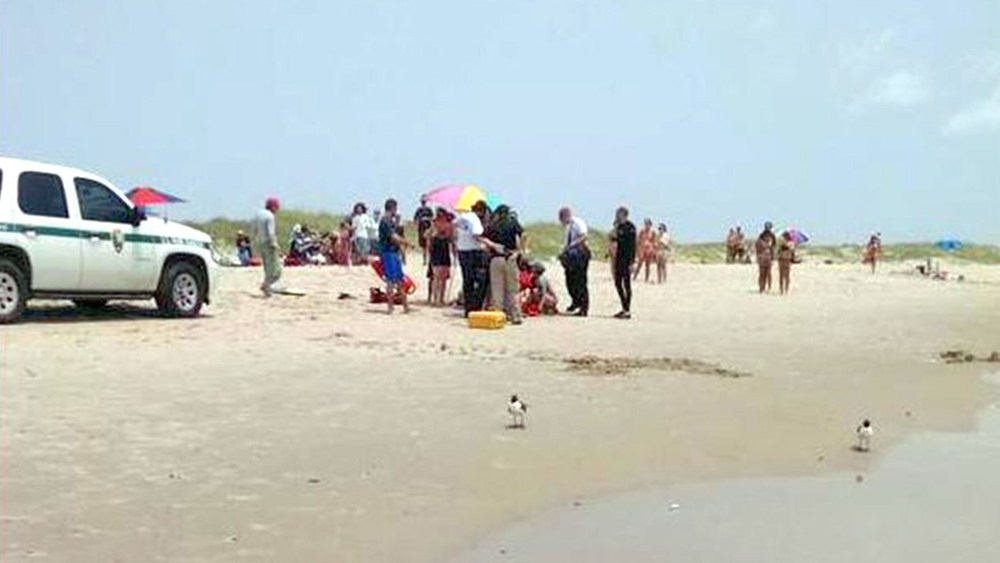 A man is treated on the beach after being attacked by a shark off Ocracoke Island in N.C. on July 1, 2015. (Photo by Jackson Fuqua)