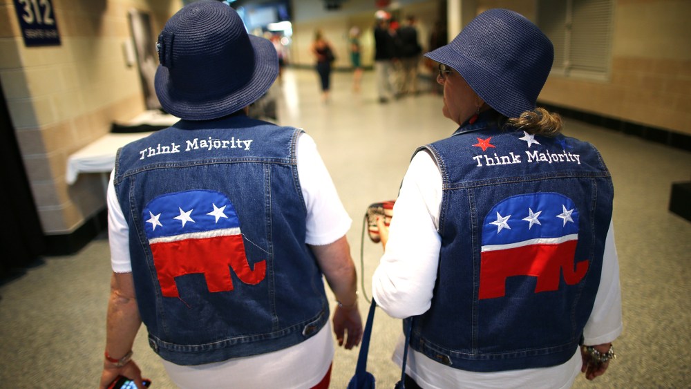 Two attendees wear GOP logo cut-off jean jackets during the third day of the Republican National Convention on Aug. 29, 2012 in Tampa, Florida.