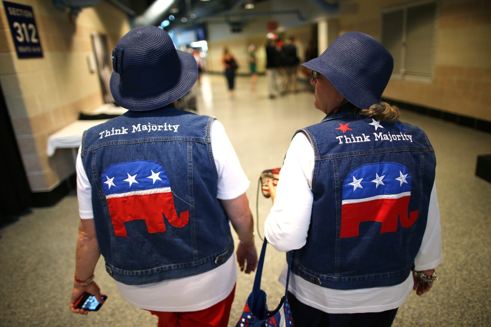 Two attendees wear GOP logo cut-off jean jackets during the third day of the Republican National Convention on Aug. 29, 2012 in Tampa, Florida.
