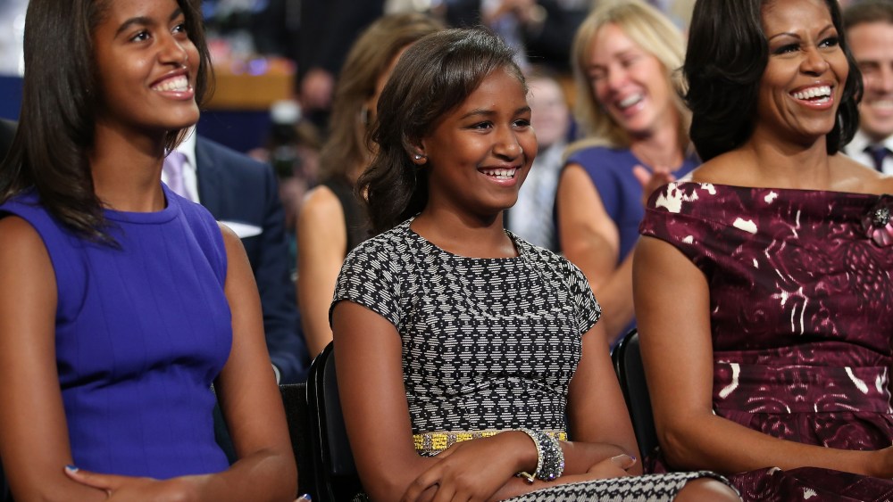 File photo: Malia Obama, Sasha Obama and first lady Michelle Obama listen as President Obama speaks at the DNC in Charlotte, North Carolina on September 6, 2012.  (Photo by Chip Somodevilla/Getty Images)