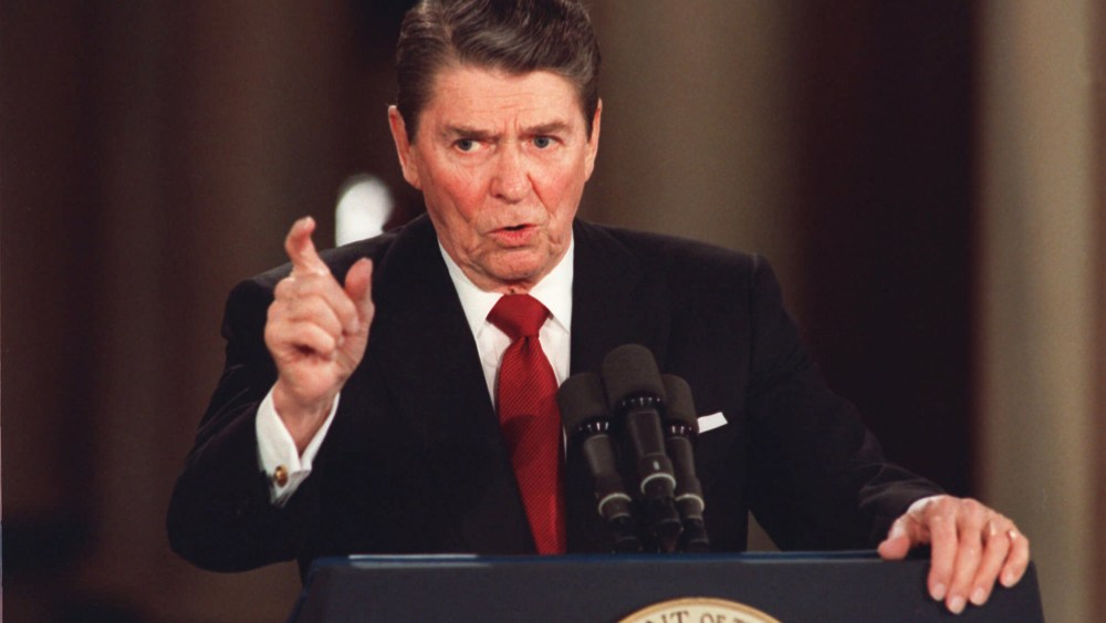 In this March 19, 1987 file photo, President Reagan gestures during a news conference at the White House in Washington.